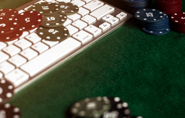 istock online casino keyboard, chips on a green table 1250717673
