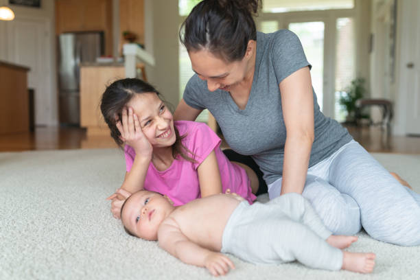 istock Portrait of ethnic mom interacting with her two young daughters 1250718203