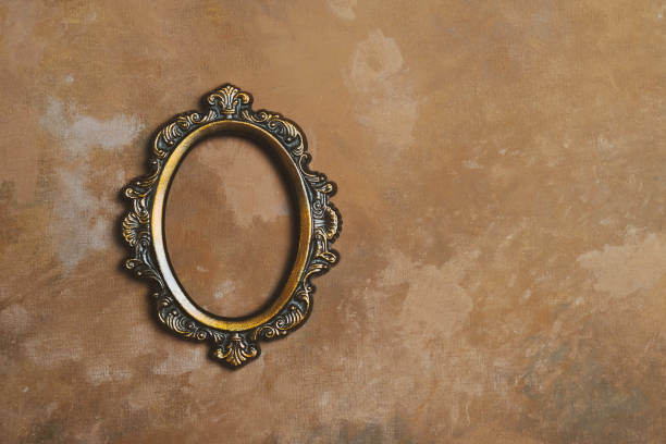 istock Empty round bronze picture frame on vintage brown wall. 1250719255