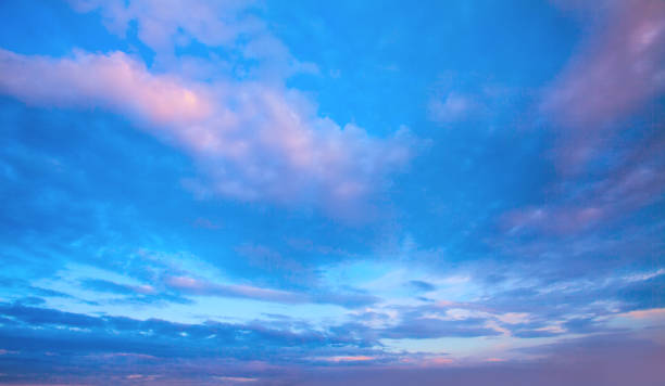 istock Sunset sky clouds background. Beautiful landscape with clouds and orange sun on sky 1250719289