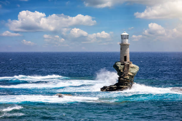 istock A lighthouse on a rock in the blue sea, Andros, Greece 1250720772