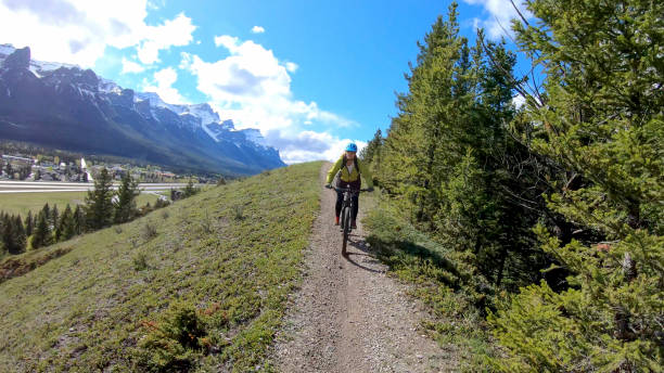 istock Female mountain e- biker rides along mountain ridge 1250720851