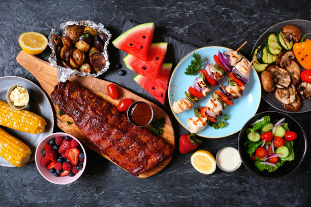 istock BBQ or summer picnic food table scene over a dark stone background 1250721046