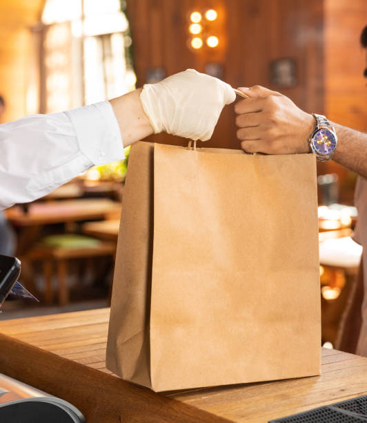istock Worker giving a ready food order bag to the client 1250721053