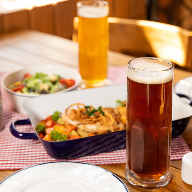 istock Dark and white beer glasses with dish 1250721078