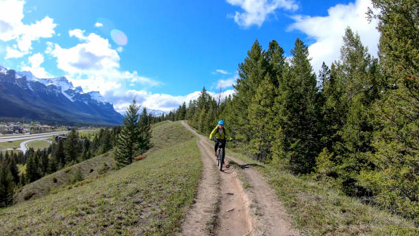 istock Female mountain e- biker rides along mountain ridge 1250721334