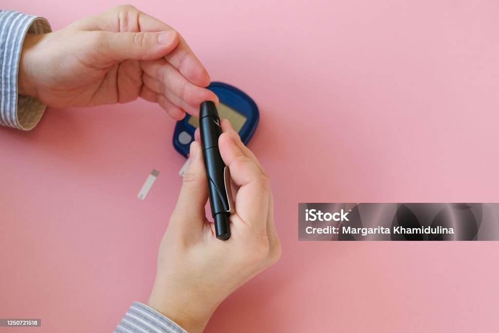 Woman Using Glucometer Woman Doing Blood Glucose Measurement Using Glucometer Stock Photo ...