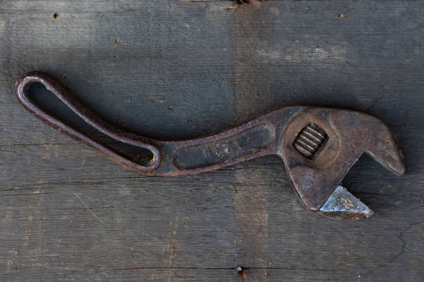 istock Old wrench on a wood board 1250723415