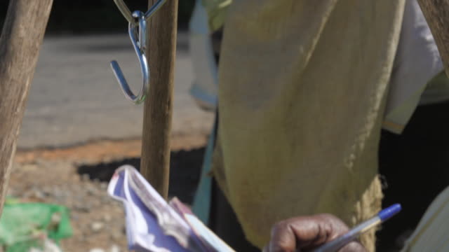 lady hand with pen writes weight results in notebook