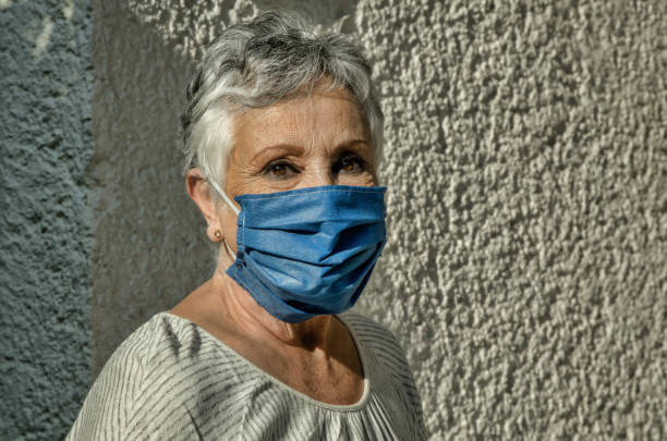 istock Grandma smiling behind the mask 1250723889