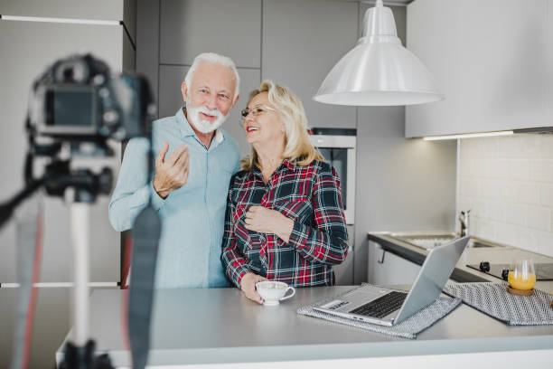 istock Senior couple vlogging at home 1250729427