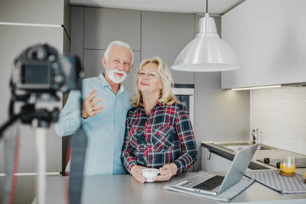 istock Senior couple vlogging at home 1250729461