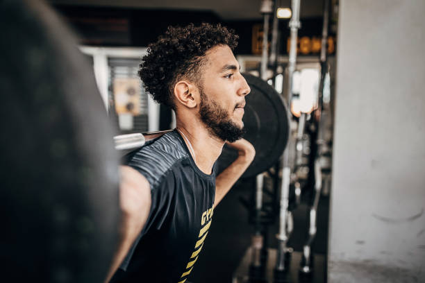 istock Young man volleyball player training with weights in the gym 1250730027