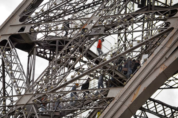 Paris, France - October 2019: Completed in 1889, the Eiffel Tower is the iconic symbol of Paris. A series of elevators takes visitors to the viewing platform at the summit of the tower and the lower tiers below. Stairs are also available to the second tier but it's easier to walk down than up.
