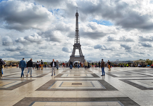 Paris, France - October 2019: Completed in 1889, the Eiffel Tower is the iconic symbol of Paris. The Esplanade du Trocadero is a favorite place to view the tower. The plaza teems with people day and night.