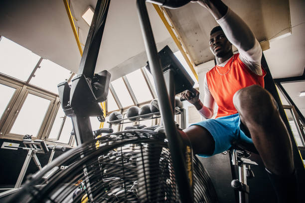 istock One young man volleyball player training on exercise bike 1250731545
