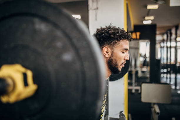 istock One man volleyball player training with weights in the gym 1250732194