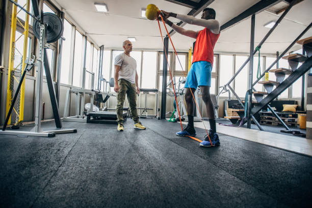 istock One man volleyball player training with personal trainer in the gym 1250732211