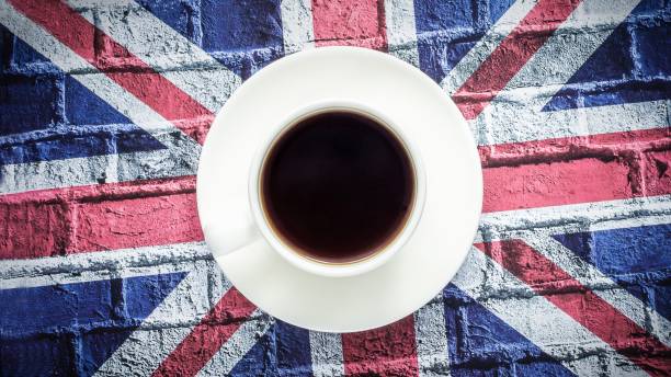 istock White cup of black coffee and British flag, Union Jack 1250732333