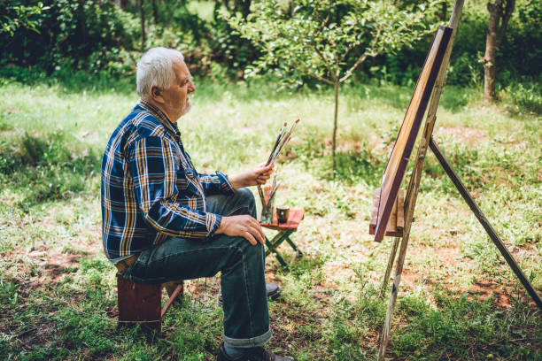 istock Retired man painting on canvas 1250732359