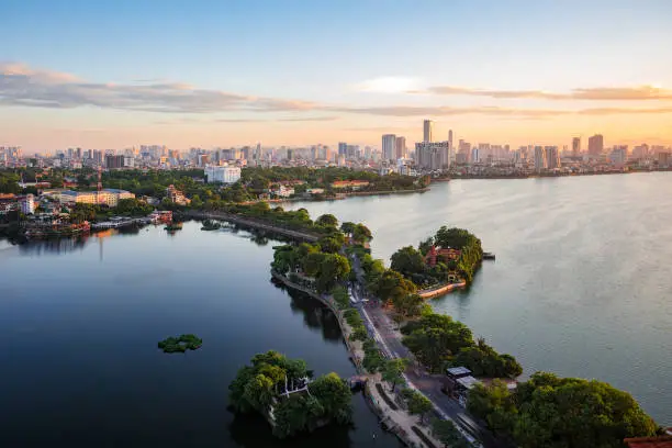 Aerial view of Hanoi skyline showing West Lake and Tay Ho District at sunset in Hanoi, Vietnam.
