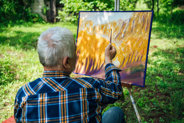 istock Older man painting on canvas 1250732463