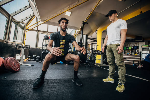 istock Man volleyball player training in the gym with a personal trainer 1250734920