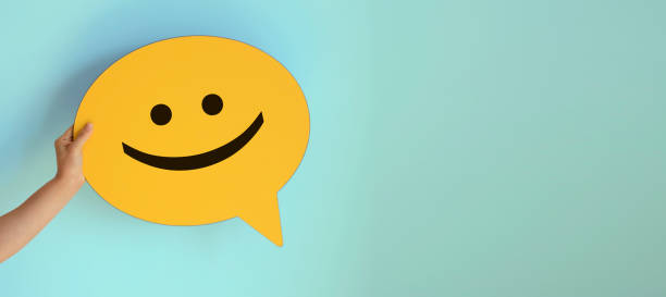 istock Women holding yellow speech bubble with smiley face 1250735834