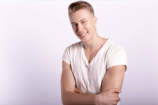 istock Sexy smiling male model against white background 1250737085