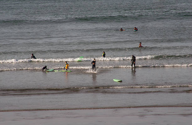 Rabat, Morocco - November 09, 2016: People Surfing in the ocean at the mouth of the Bou Regreg river from the Atlantic Ocean. Rabat, Morocco