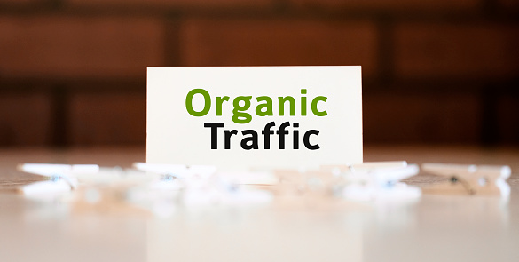 Organic seo traffic - text of business concept on white list and with clothespins