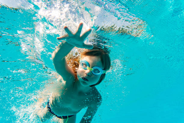 istock Little child is diving in swimming pool 1250739935