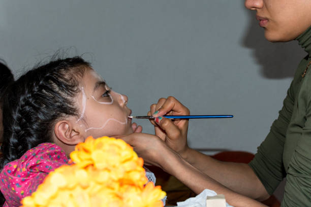istock woman putting makeup on girl 1250752378