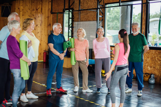 istock Young instructor gathering seniors for a group yoga class 1250775948