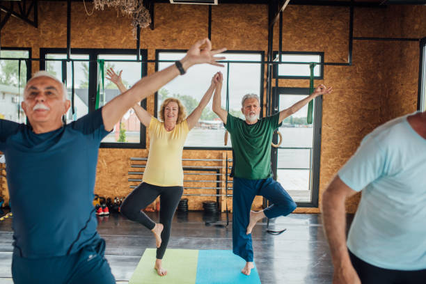 istock Seniors balancing together, doing yoga 1250776475