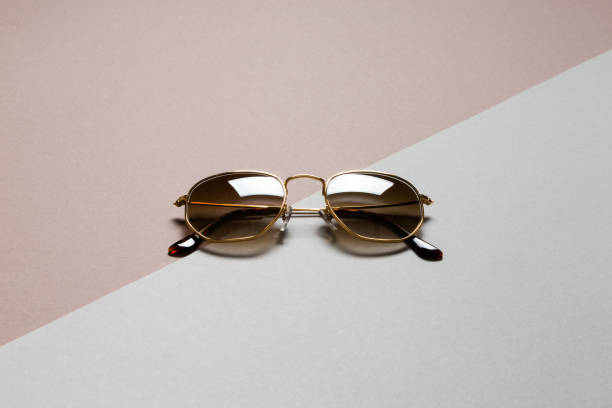 istock Hipster golden frame sunglasses on abstrcat diagonal background with copy space 1250777536