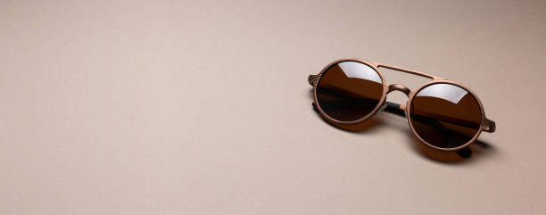 istock Brown classy sunglasses on minimal paper background 1250777537