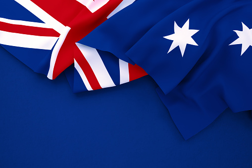 Australian flag on navy blue background. Horizontal composition with copy space. Directly above.