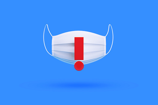White surgical mask with red exclamation point over blue background, Horizontal composition. Illness prevention concept.