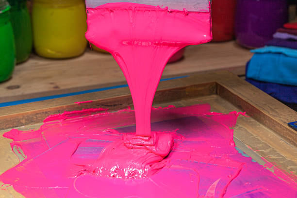 istock pink color dripping from hand screen printing 1250795367