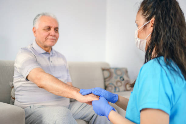 holding patient's hand for health care trust and support holding patient's hand for health care trust and support parkinsons disease photos stock pictures, royalty-free photos & images