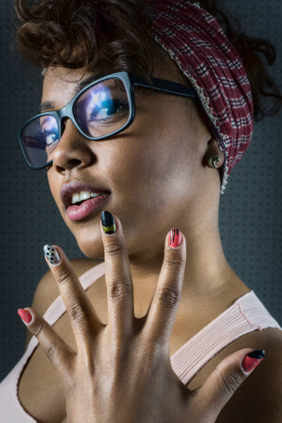 Black young woman facing camera smiling showing her nails - Close up shot