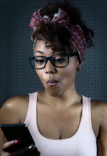 istock Surprised black woman looking at smartphone 1250799129