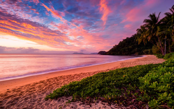 Amazing sunrise sky viewed by Trinity Beach Trinity Beach is part of Cairns in Queensland cairns australia photos stock pictures, royalty-free photos & images