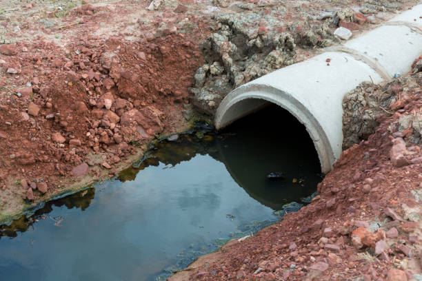 istock Concrete circular run-off pipe discharging water. sewage pipe polluting the river. Sewage or domestic wastewater or municipal wastewater that is product by community of people. 1250844098