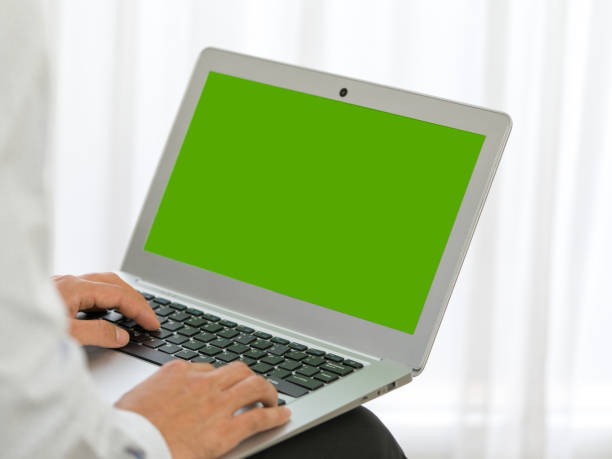 istock Business man hands typing on laptop computer with green screen. 1250848590