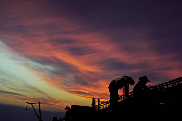 istock Silhouette Construction worker of Building crane on construction site background. 1250894981