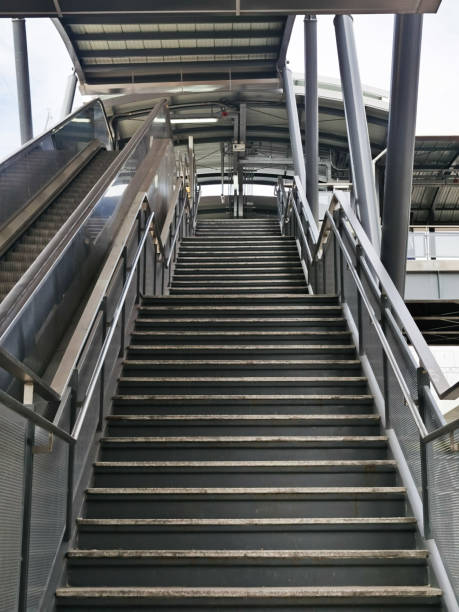 istock Architecture construction of elevator, escalator stairs and sky walk way, walk bridge between sky train station and department store mall 1250904516