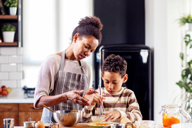 istock Woman prepare pie in the kitchen and learn his son cooking 1250908437