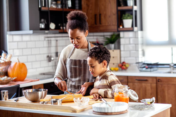 istock Woman prepare pie in the kitchen and learn his son cooking 1250908528